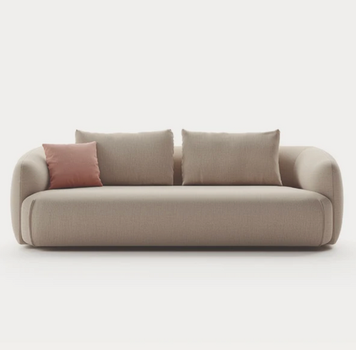 Curved boucle 3-seater sofa in warm sand with blush pink accent cushion