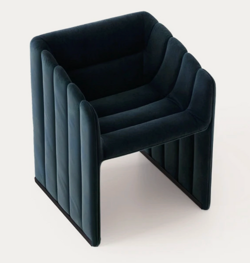 Channel-tufted midnight navy velvet armchair with wraparound upholstered body