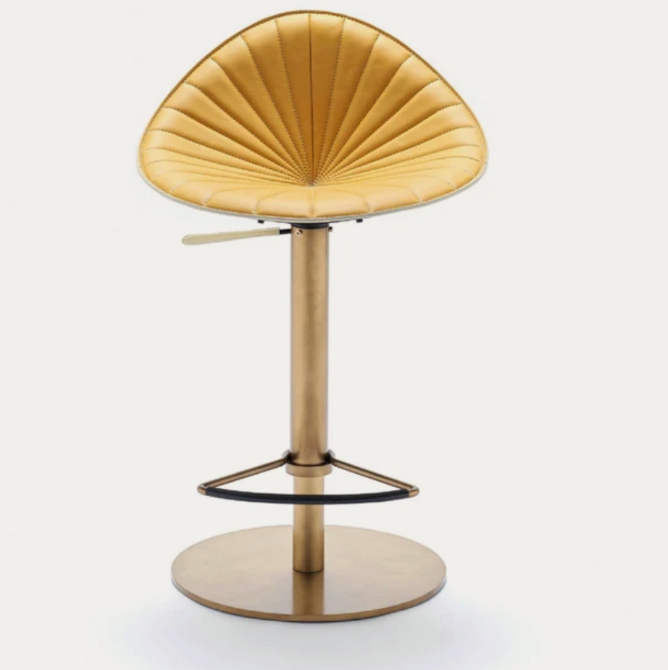 Fan-back gold velvet bar stool with pleated backrest and antique brass pedestal base with footrest ring
