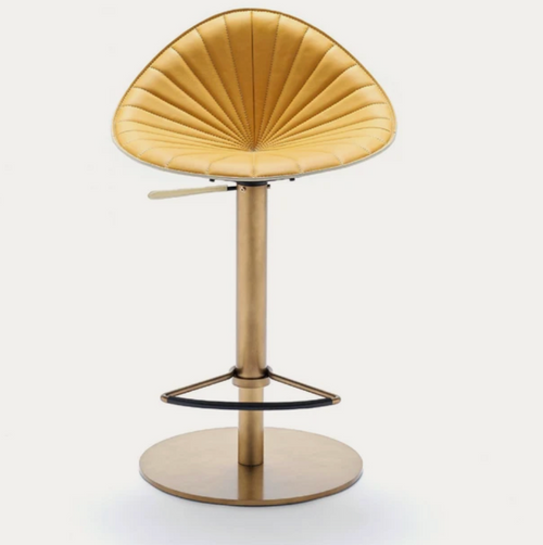 Fan-back gold velvet bar stool with pleated backrest and antique brass pedestal base with footrest ring